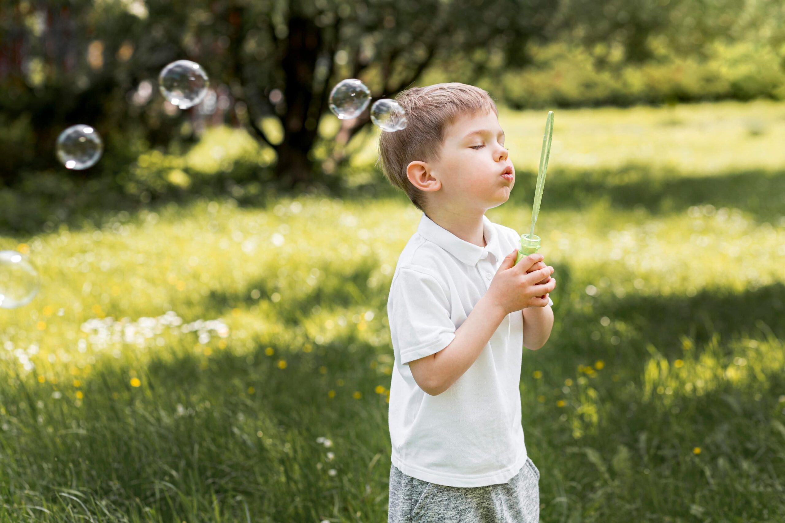 cute-child-blowing-bubbles-with-his-toy (1)
