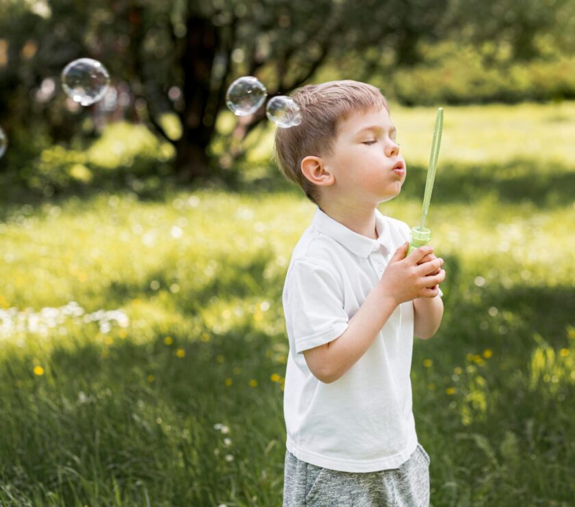 cute-child-blowing-bubbles-with-his-toy (1)